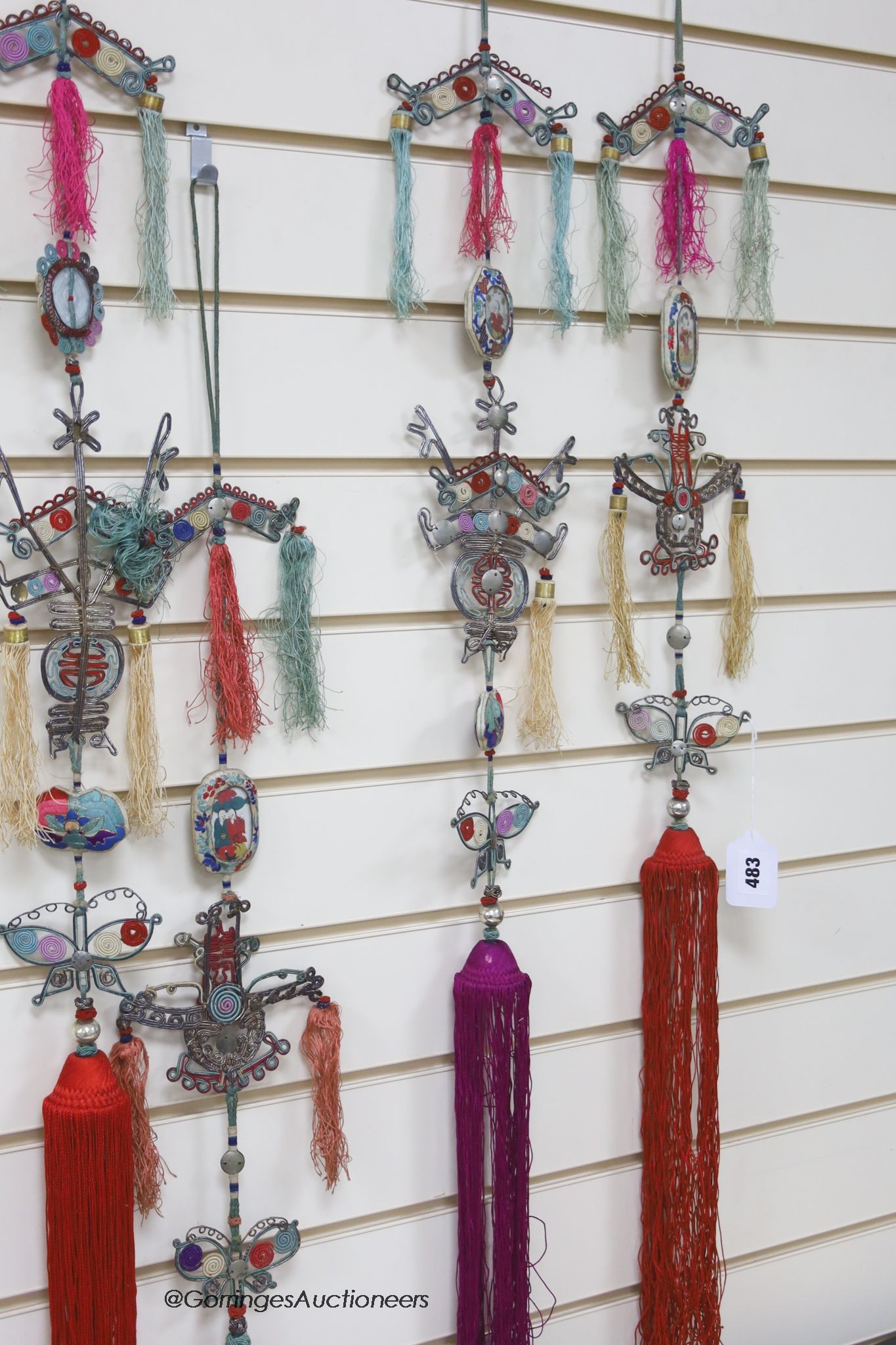 Eight 20th century Chinese embroidered, tasselled and wireworked ceremonial hangings, longest 130cm